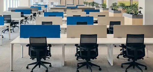 Modern open-plan office space featuring clean workstations, ergonomic chairs, and sanitized carpets provided by professional office cleaning services in Orange, CA.