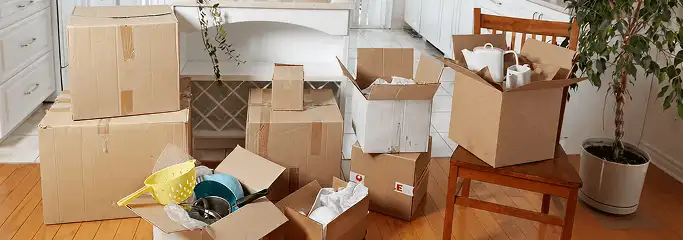 Packed moving boxes and household items in a kitchen before move-out or move-in cleaning, Orange, CA.